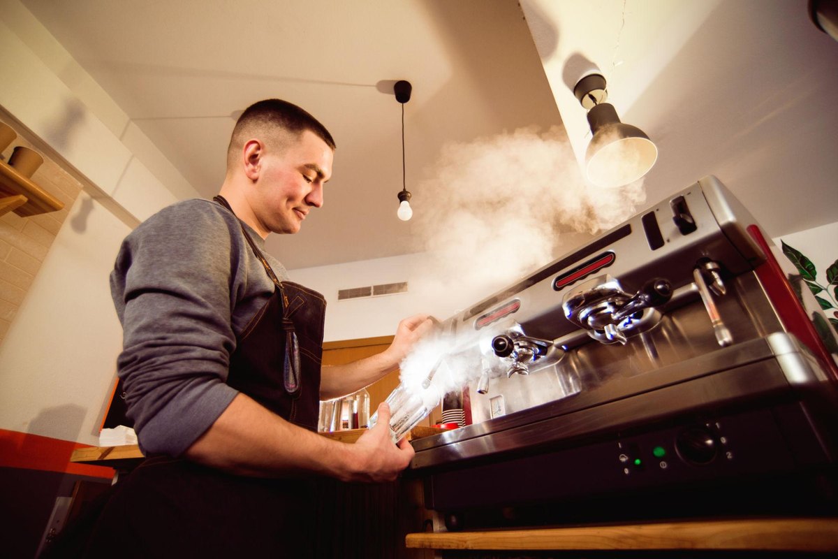 Barista servicing espresso machine